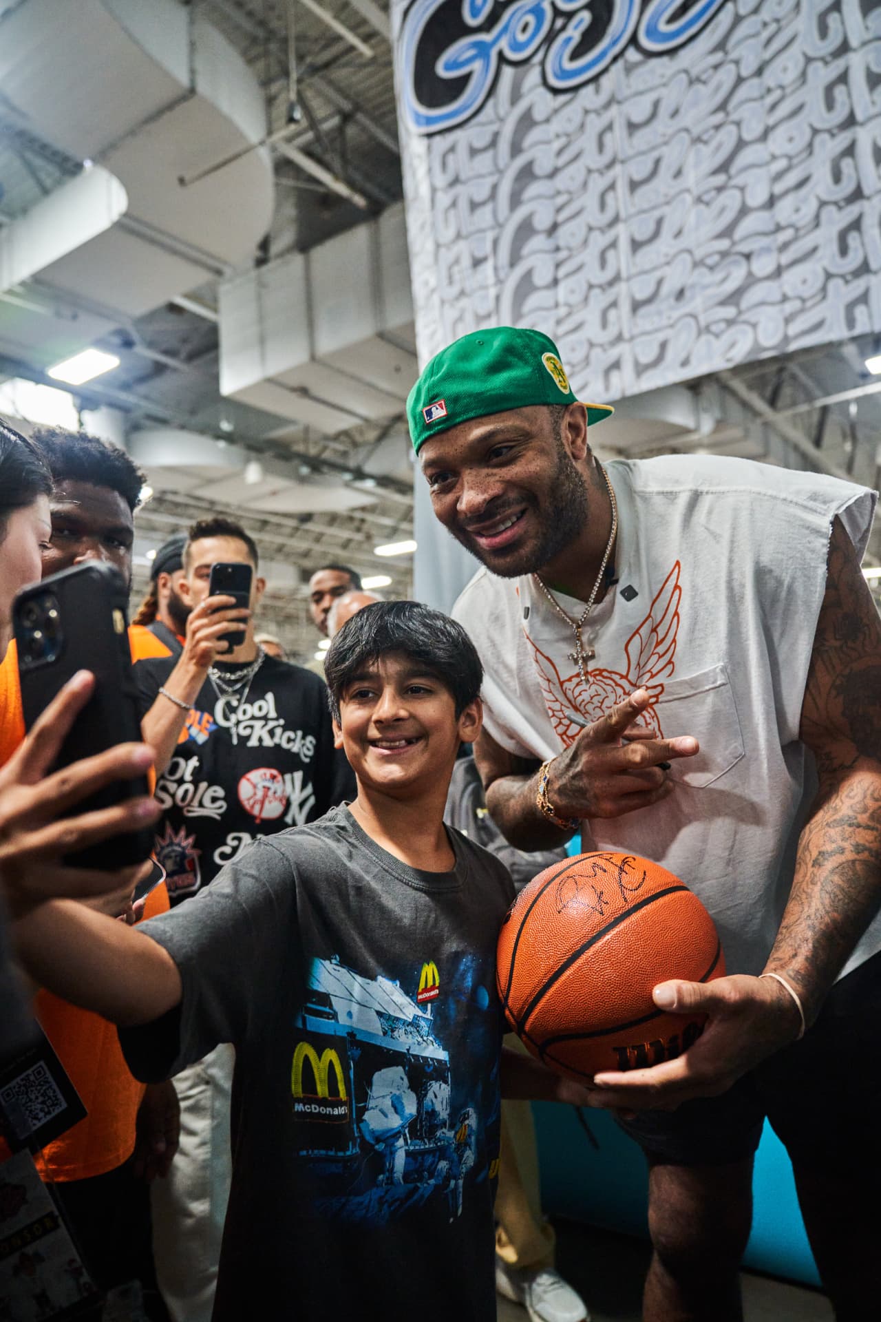 P.J. Tucker signing a basketball and meeting fans at the POIZON Got Sole activation